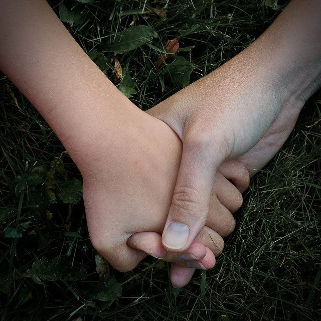 holding a child's hand