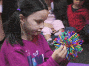 girl expanding and contracting Hoberman Sphere