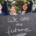 kids holding sign saying we are the future