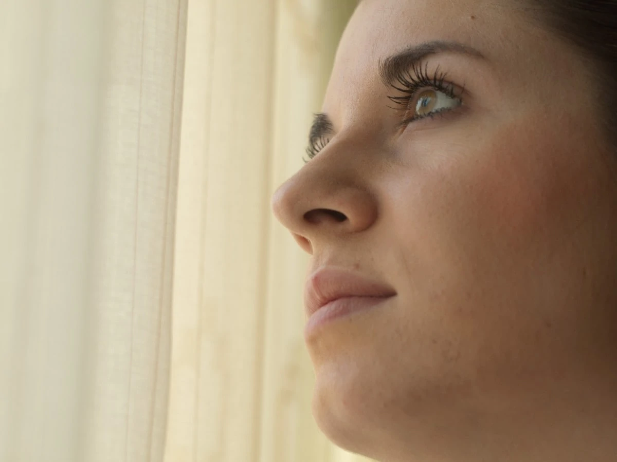 woman looking up thoughtfully