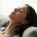 woman lying back with eyes closed