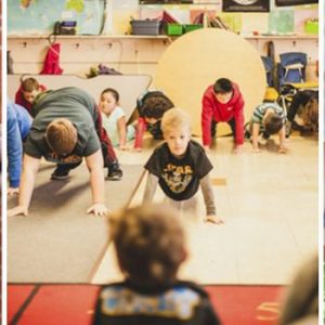 kids doing yoga in classroom
