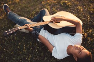 teen boy playing guitar