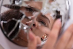 woman's face in broken mirror