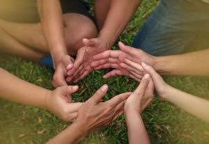 several people's hands forming a circle