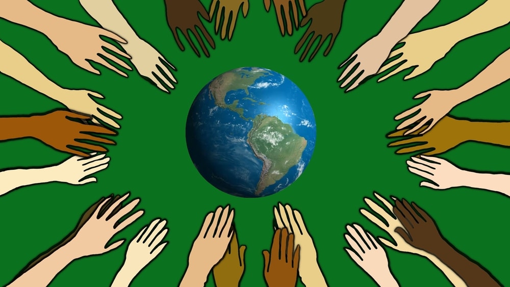 diverse hands surrounding Earth