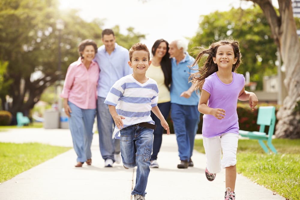multi-generational family walking in park