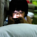 young child transfixed by smartphone