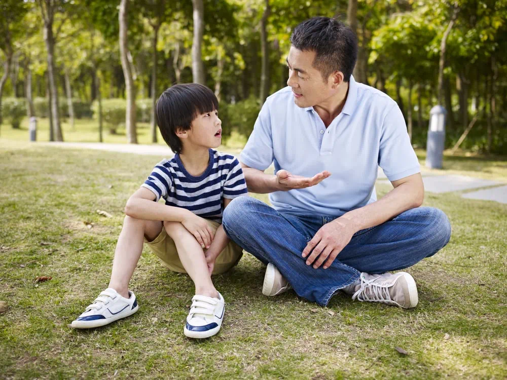 father talking with son outdoors