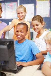 smiling kids at computer